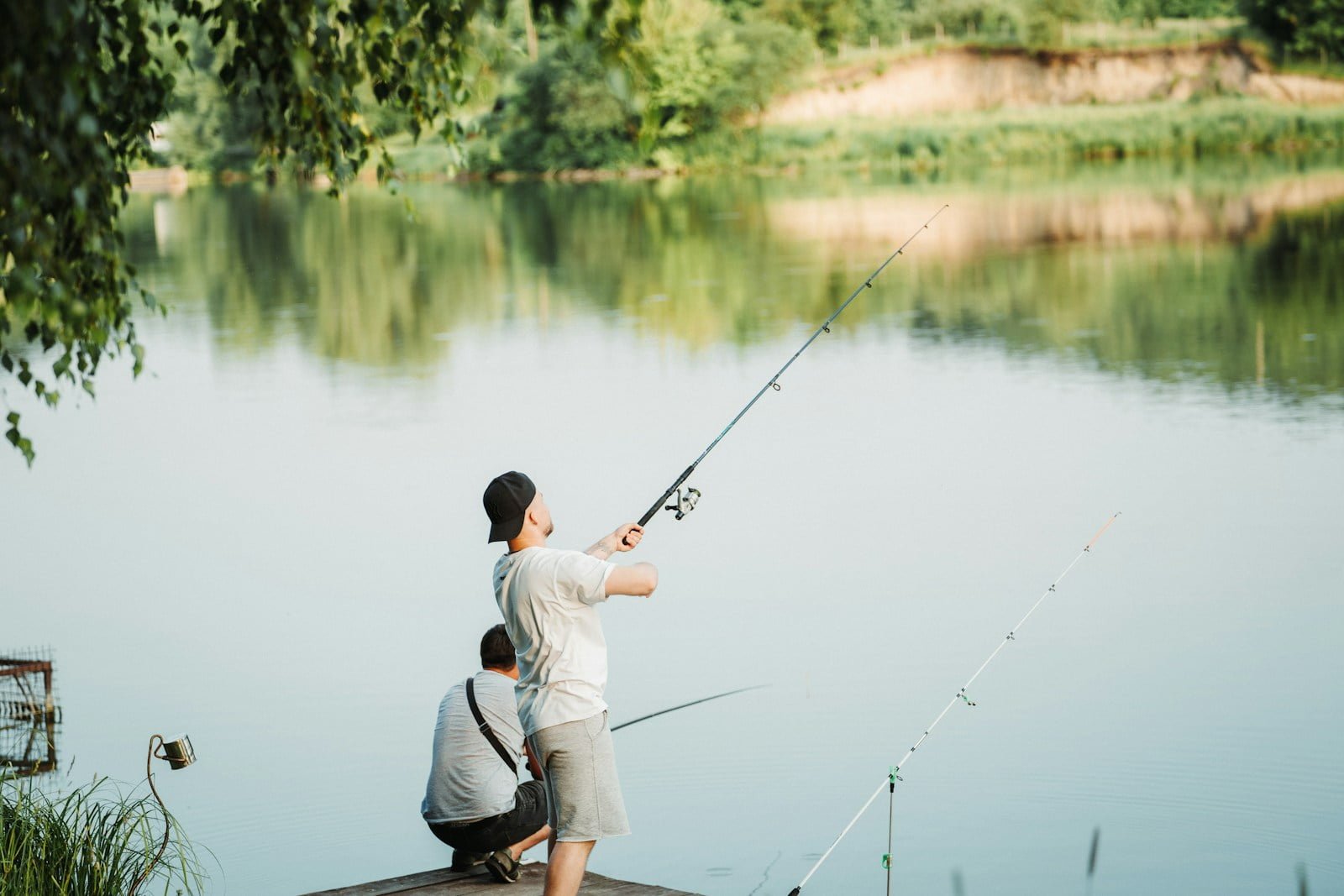 a man and a boy fishing on a dock